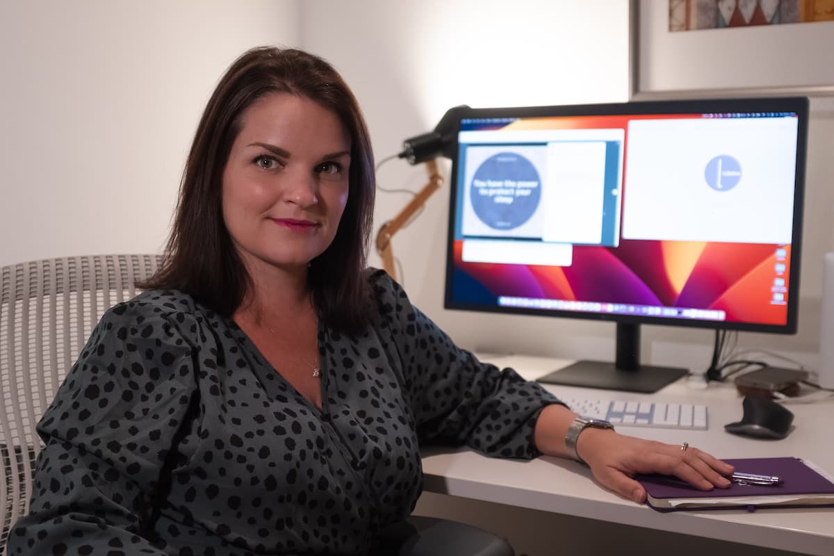 Lisa Adair, IBCLC and registered NICU nurse, at the desk where she wrote the guide